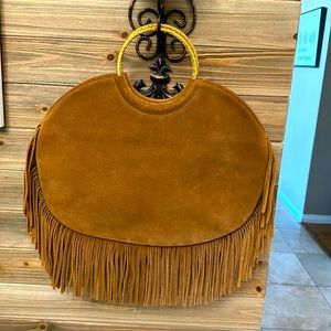 Authentic “vintage”y Saint Laurent suede fringe bag with gold hardware handle.